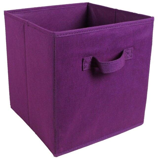 a purple pink suitcase sitting on a white surface 